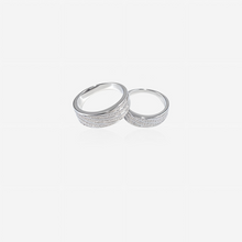 Couple silver rings on a light gray background