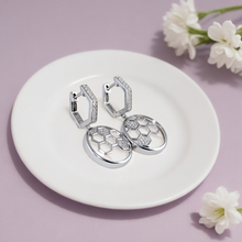 Pair of silver hoop earrings with diamond accents