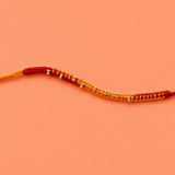 Saffron Weave Silver Bead Rakhi