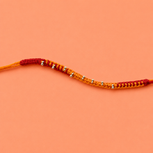 Saffron Weave Silver Bead Rakhi