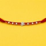 Silver Om Charm Rakhi with Floral Beads Thread
