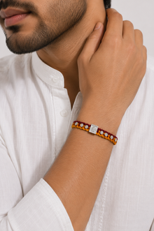 Divine Ganesha Silver Rakhi with Handwoven Thread