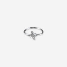 Silver ring with a small diamond on a white background