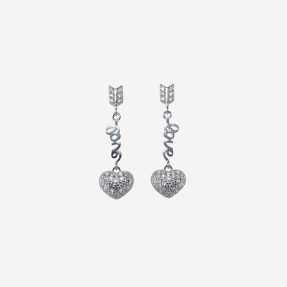 Pair of silver heart-shaped earrings with 'LOVE' inscription on a white background